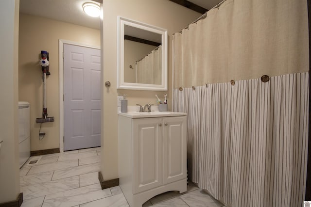 full bathroom with baseboards, marble finish floor, and vanity