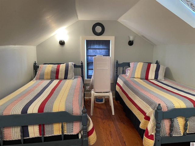 bedroom featuring wood finished floors and vaulted ceiling