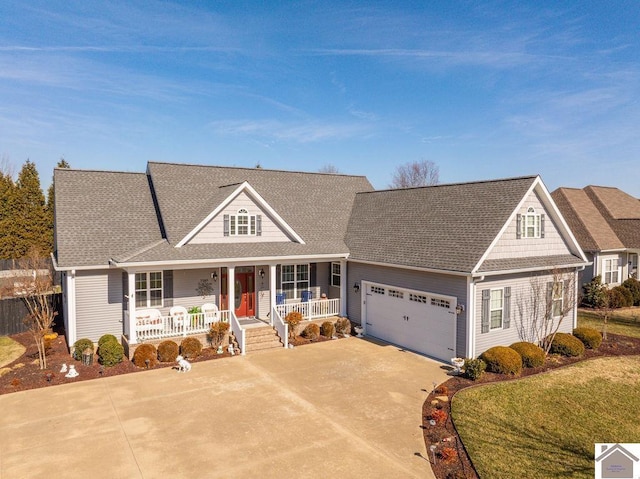 view of front of house with a garage, roof with shingles, a porch, and concrete driveway