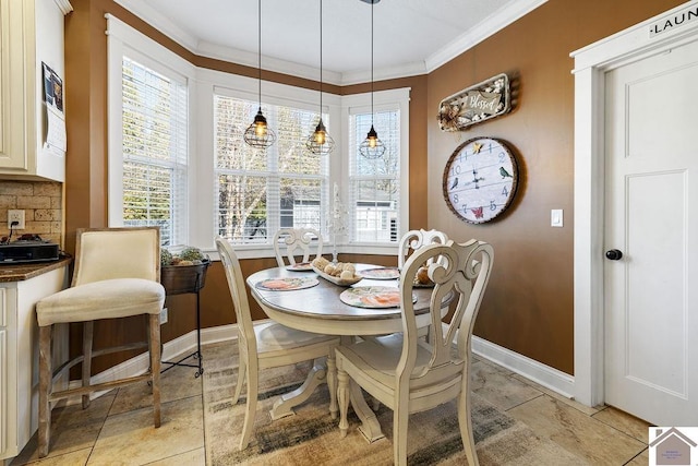 dining room with baseboards and ornamental molding