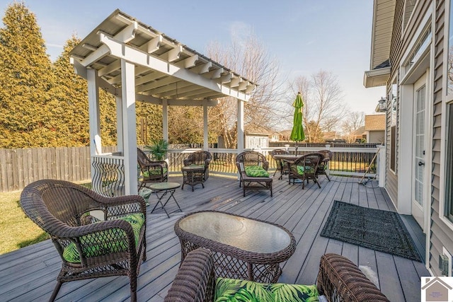 wooden terrace featuring outdoor dining space and fence