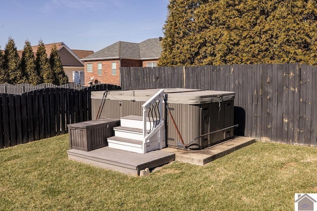 view of yard featuring a fenced backyard and a hot tub