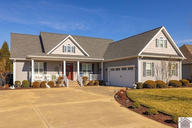 view of front facade with driveway, roof with shingles, an attached garage, covered porch, and a front lawn