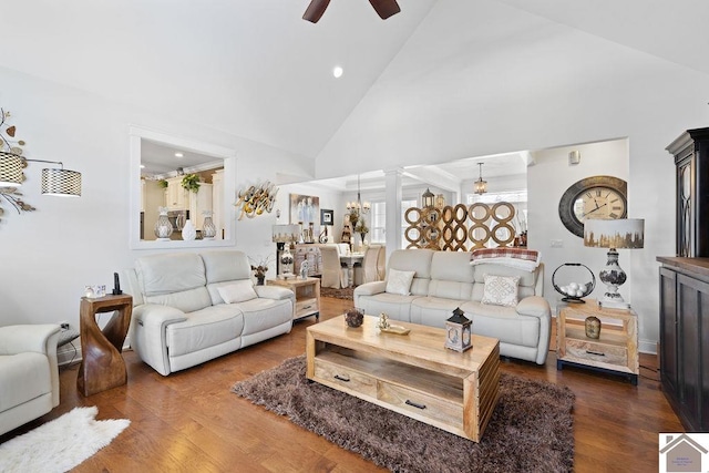 living area with high vaulted ceiling, wood finished floors, and a ceiling fan