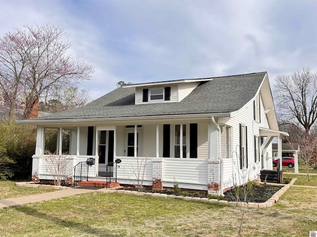 view of front of house featuring a porch, a front yard, and roof with shingles