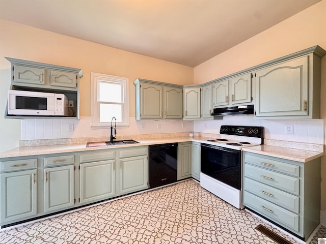 kitchen with under cabinet range hood, light floors, light countertops, white appliances, and a sink