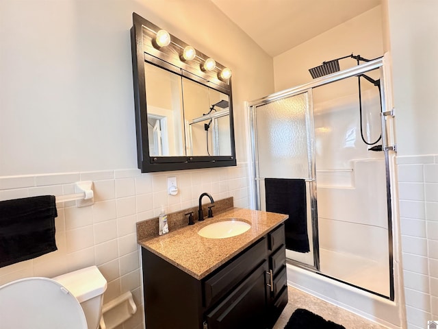 full bath featuring tile walls, toilet, and a stall shower