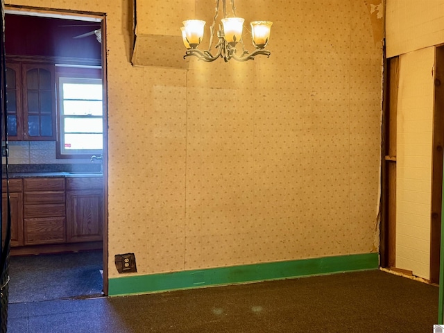 504 Pine St, Murray, KY 42071 - unfurnished dining area featuring a sink, an inviting chandelier, and wallpapered walls
