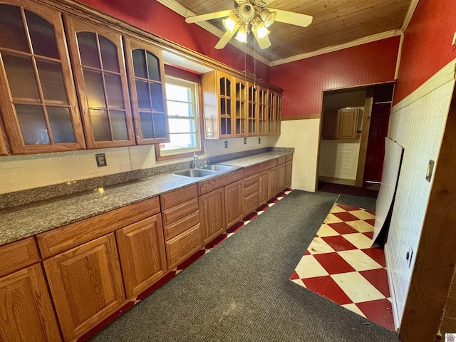 504 Pine St, Murray, KY 42071 - kitchen with ornamental molding, dark floors, a sink, ceiling fan, and glass insert cabinets