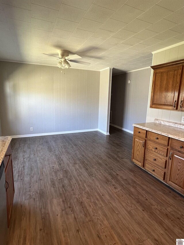 kitchen featuring open floor plan, baseboards, dark wood finished floors, a ceiling fan, and brown cabinetry