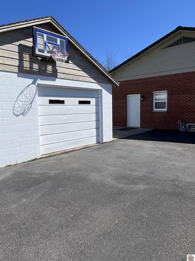garage featuring aphalt driveway