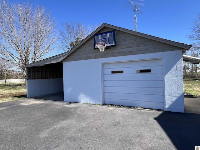 garage with driveway and a garage