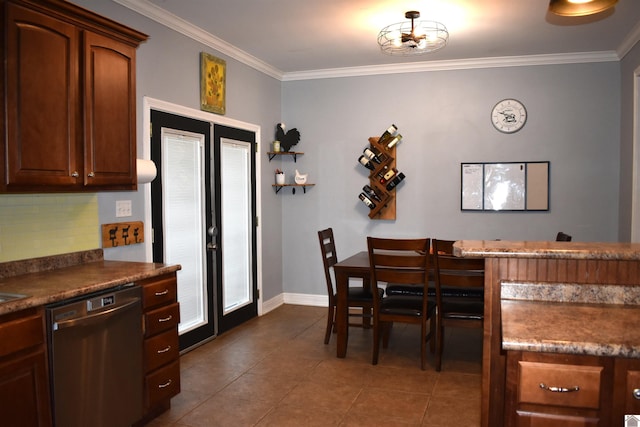dining area featuring baseboards, dark tile patterned flooring, and ornamental molding