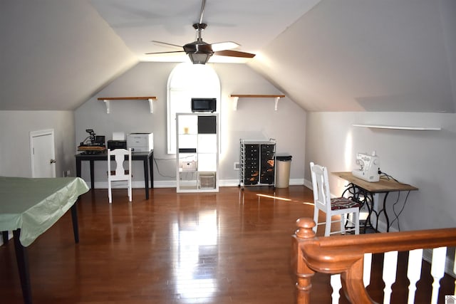 office space with baseboards, lofted ceiling, wood finished floors, and ceiling fan