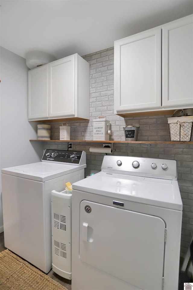 laundry area featuring washing machine and dryer and cabinet space