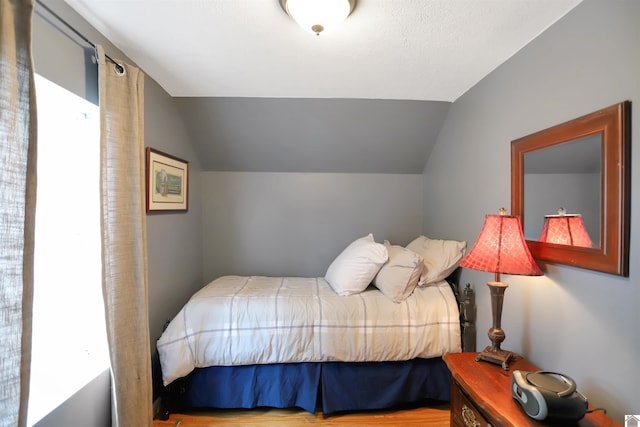 bedroom with lofted ceiling