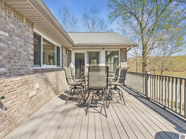 wooden terrace featuring outdoor dining area
