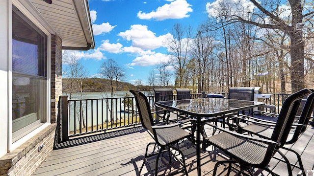 wooden deck featuring outdoor dining area