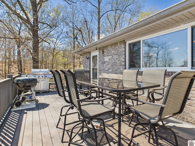 wooden terrace featuring outdoor dining area