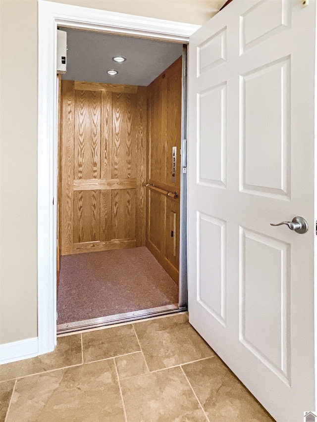 room details featuring elevator and baseboards