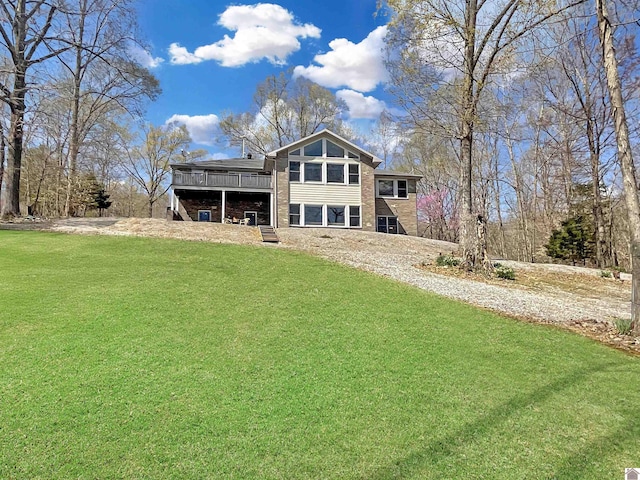 view of front of home featuring a wooden deck and a front yard