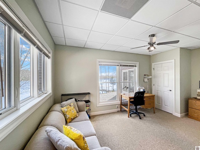 office with visible vents, baseboards, ceiling fan, light carpet, and a paneled ceiling