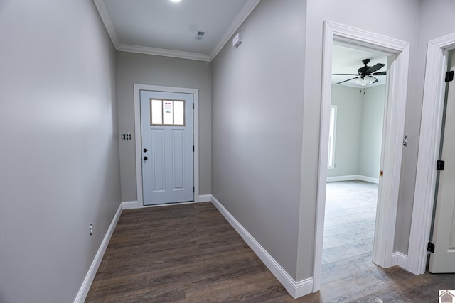 doorway to outside featuring baseboards, visible vents, ornamental molding, and dark wood finished floors