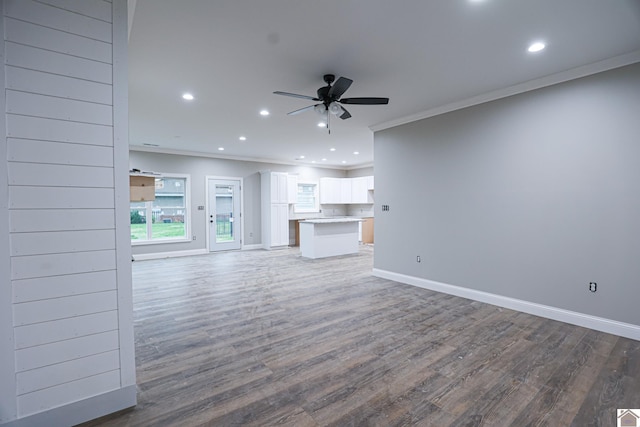 unfurnished living room featuring recessed lighting, wood finished floors, crown molding, baseboards, and ceiling fan