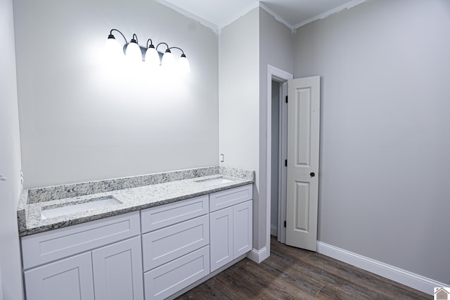 bathroom with baseboards, wood finished floors, and crown molding