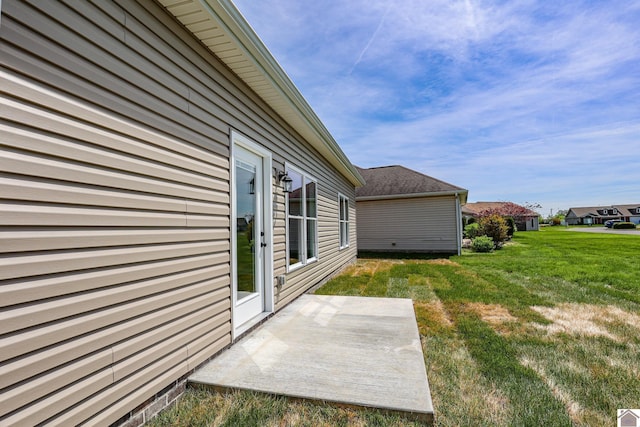 view of side of property with a patio area and a yard