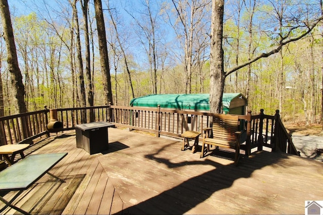 wooden terrace with a wooded view