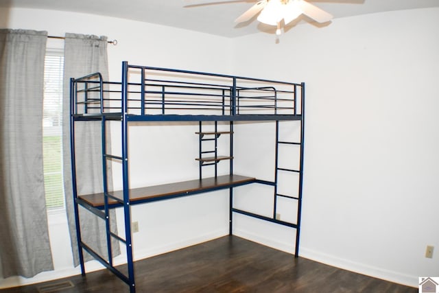unfurnished bedroom with wood finished floors, baseboards, and visible vents