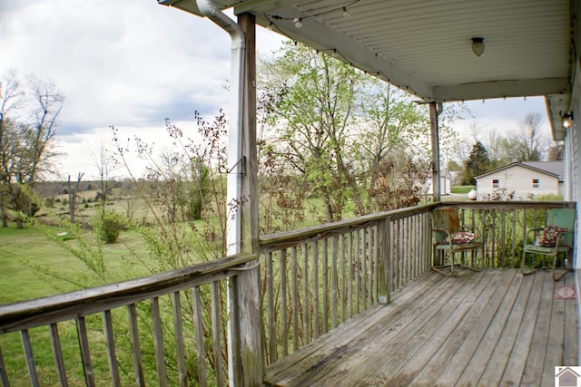 wooden terrace with a yard