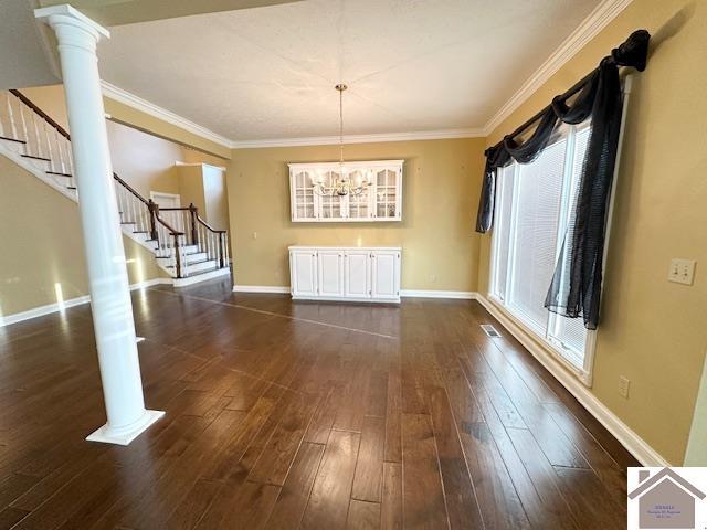 unfurnished dining area with baseboards, dark wood-style floors, visible vents, and stairway