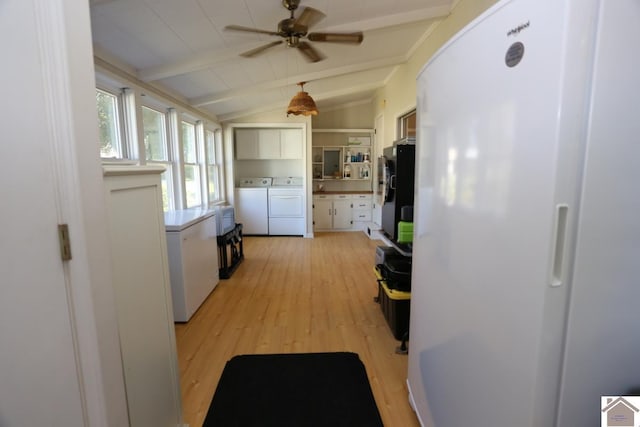 kitchen with separate washer and dryer, lofted ceiling with beams, freestanding refrigerator, a ceiling fan, and light wood-style floors