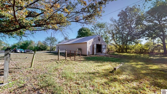 view of yard with fence and an outbuilding