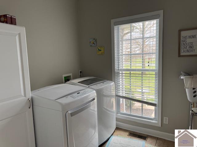 198 Smith Ln, Mayfield, KY 42066 - washroom featuring visible vents, washer and dryer, light tile patterned flooring, and laundry area