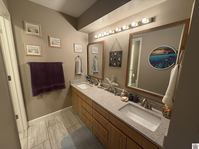 6060 State Route 94 W, Murray, KY 42071 - bathroom with a sink, baseboards, and double vanity