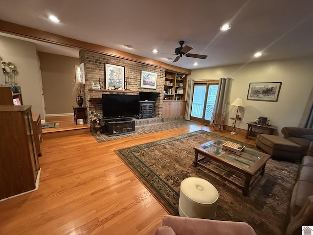 6060 State Route 94 W, Murray, KY 42071 - living room with baseboards, recessed lighting, a brick fireplace, ceiling fan, and wood finished floors