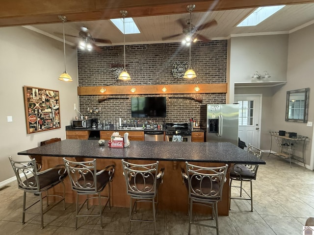 6060 State Route 94 W, Murray, KY 42071 - kitchen featuring dark countertops, a skylight, appliances with stainless steel finishes, and a ceiling fan