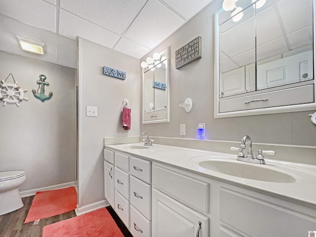 201 Blue River Rd, Cadiz, KY 42211 - full bath featuring toilet, wood finished floors, a sink, and a drop ceiling