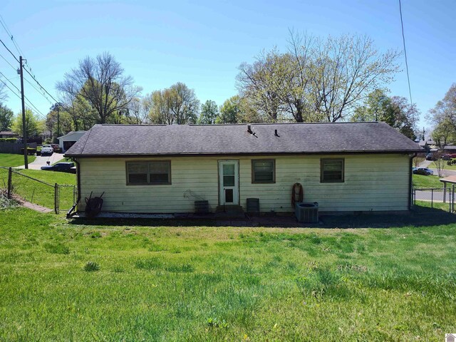 back of house featuring a yard, cooling unit, and fence