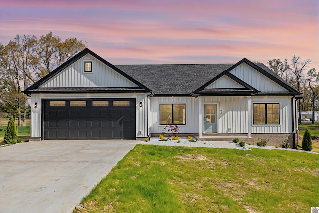 102 Ironwood Dr, Murray, KY 42071 - modern inspired farmhouse featuring an attached garage, a shingled roof, a front yard, and concrete driveway