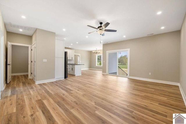102 Ironwood Dr, Murray, KY 42071 - unfurnished living room with ceiling fan with notable chandelier, baseboards, visible vents, and light wood-type flooring
