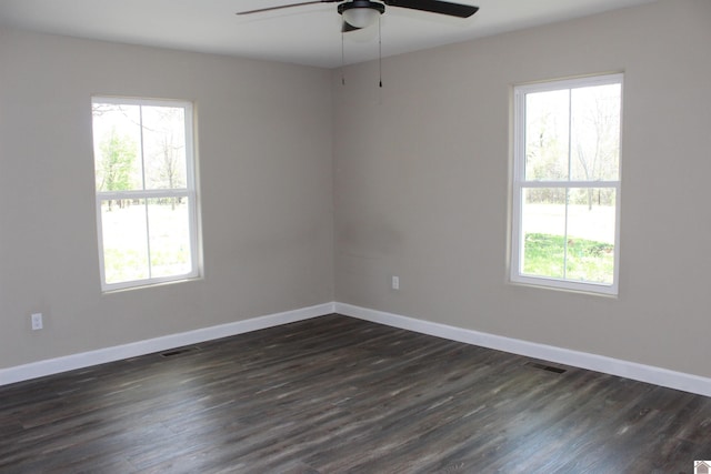 empty room with a wealth of natural light, baseboards, and ceiling fan