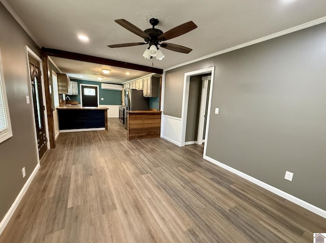 unfurnished living room featuring recessed lighting, wood finished floors, ornamental molding, baseboards, and ceiling fan
