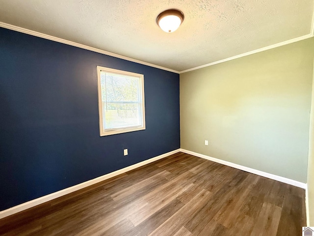 unfurnished room featuring wood finished floors, a textured ceiling, crown molding, and baseboards