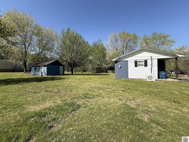 view of yard featuring an outbuilding and a storage unit