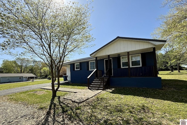 manufactured / mobile home with a front lawn and covered porch