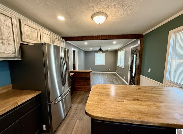 kitchen featuring freestanding refrigerator, wood finished floors, and ornamental molding